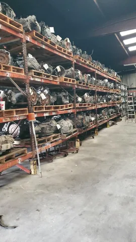 Warehouse racks filled with engines and transmissions at Engine Corner Auto Parts LLC.