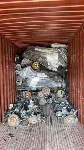Automotive parts arranged inside a shipping container at Engine Corner Auto Parts LLC.