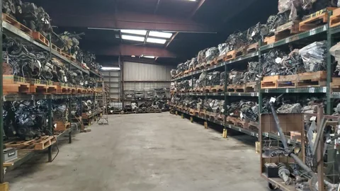 A wide warehouse aisle with organized automotive parts at Engine Corner Auto Parts LLC.