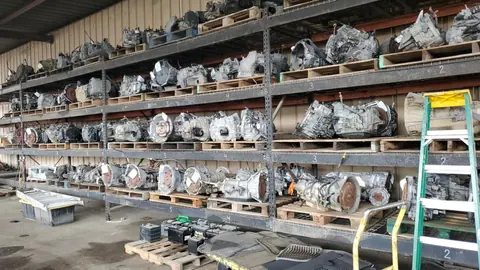 Transmission inventory organized on warehouse racks at Engine Corner Auto Parts LLC.