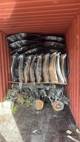 Wrapped bumpers and suspension components arranged for shipment at Engine Corner Auto Parts LLC.
