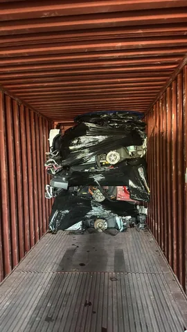 Wrapped engines arranged inside a shipping container at Engine Corner Auto Parts LLC.